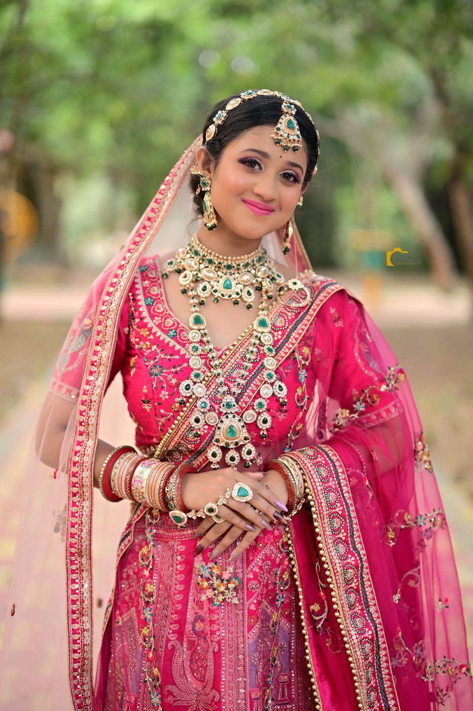 A bride in pink lehenga with kundan jewellery and luminous makeup