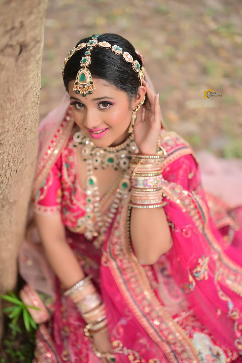 A bride in pink with layered kundan jewellery