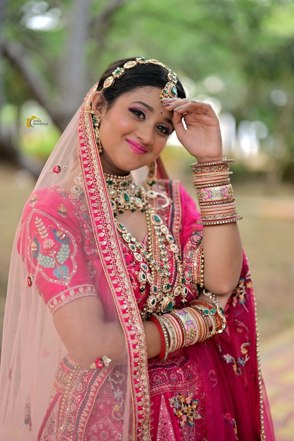 A bride in pink lehenga with soft, radiant bridal makeup