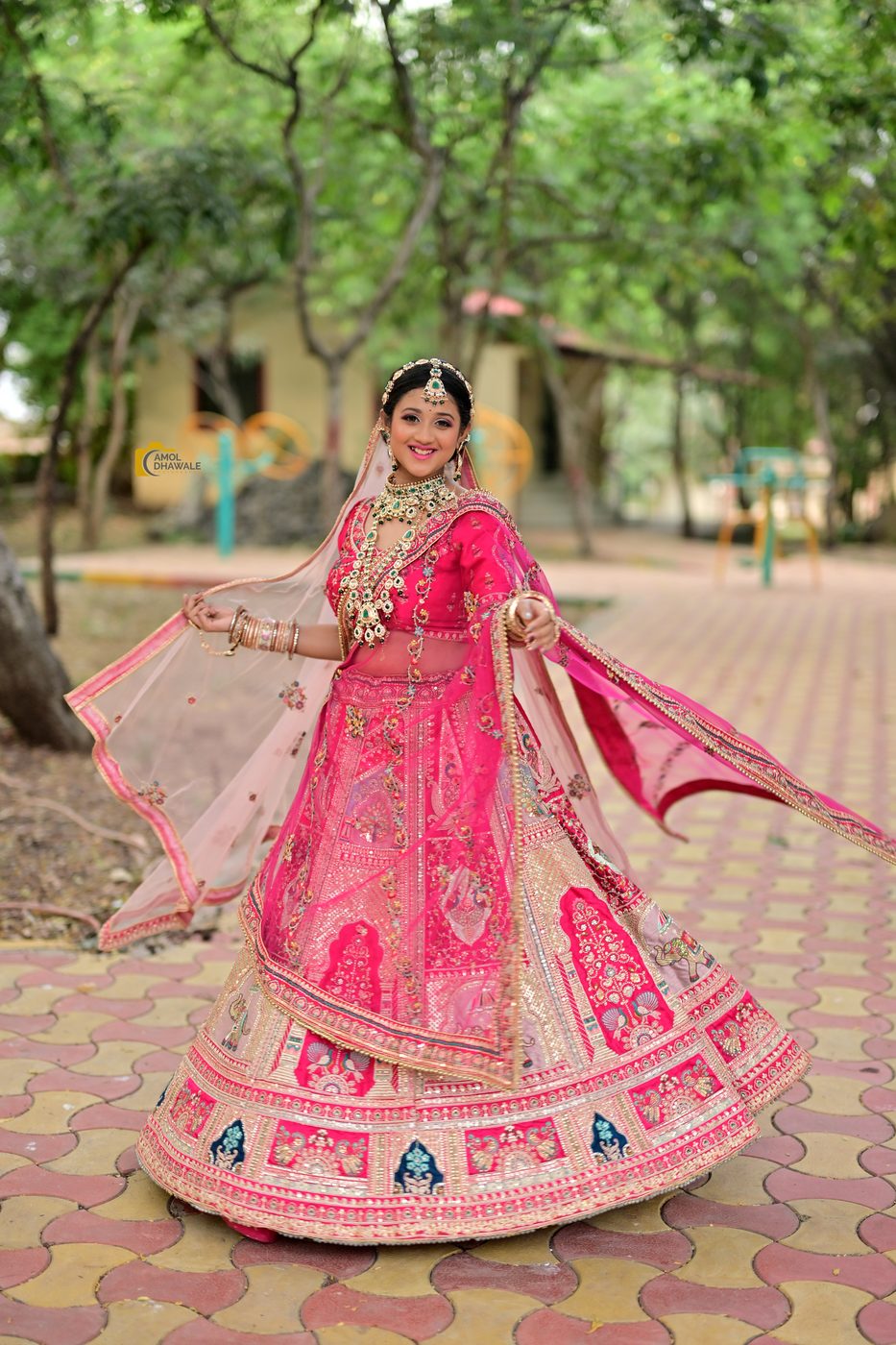 Bride twirling in a pink bridal lehenga