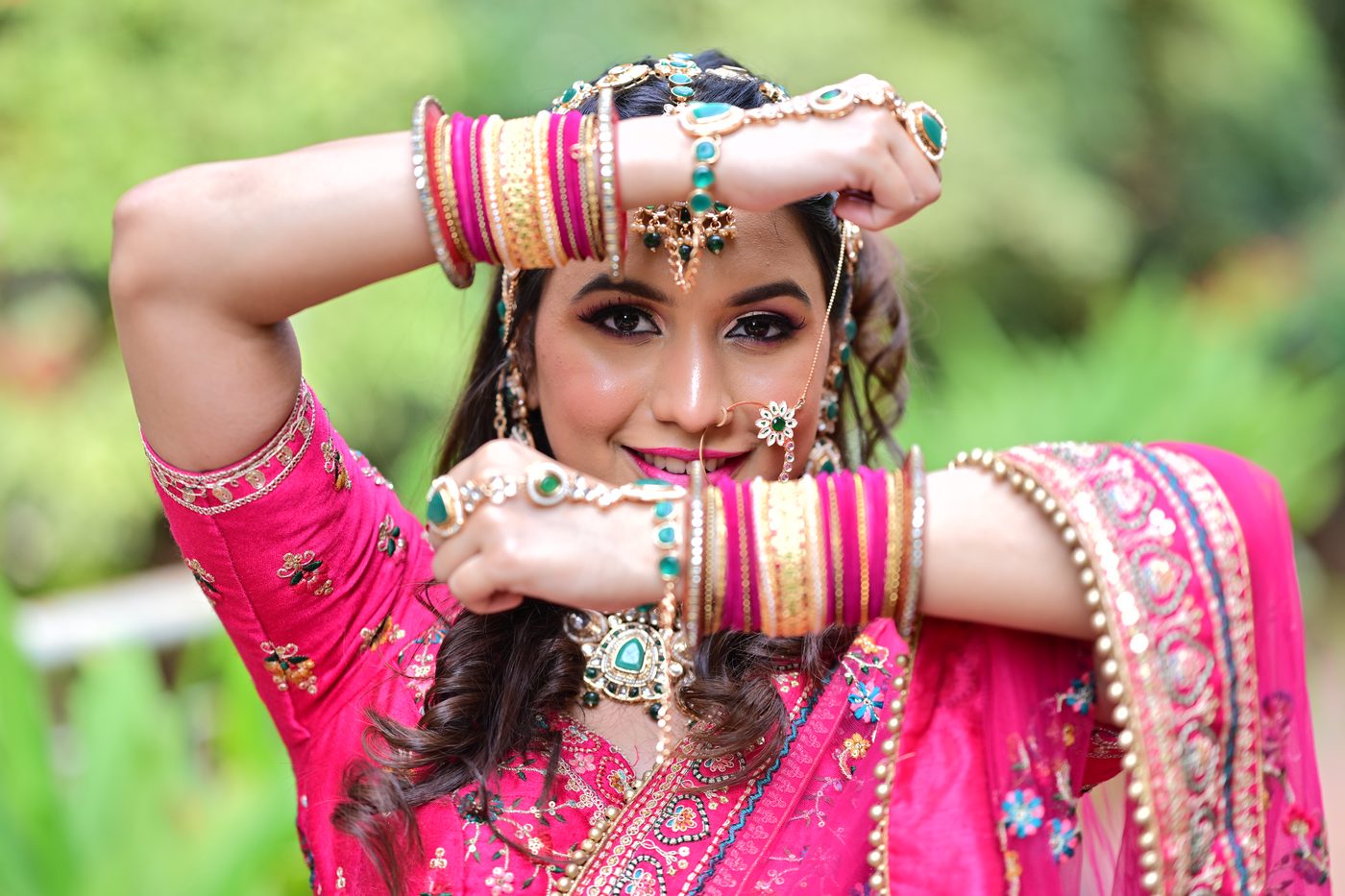 Bride framing her face with bangles, showing defined eye makeup